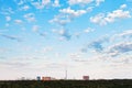 Many small white clouds in blue sky over city Royalty Free Stock Photo