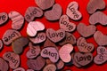 Many small wooden hearts written with the word love for valentine's day