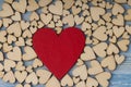 Many small wooden hearts and one big red heart  on blue background Royalty Free Stock Photo