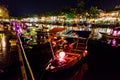 Many small wooden junk boats with traditional vietnamese lantern lamps on the river in the ancient Hoi An town center