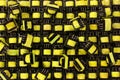 Many small yellow electrical ferrite transformers