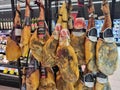 Many smoked legs of traditional Spanish meat food - jamon ham hanging at the market