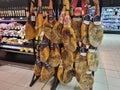 Many smoked legs of traditional Spanish meat food - jamon ham sales at the market Royalty Free Stock Photo