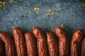 Many smoked sausages on a blue metallic background
