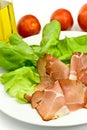 Many smoked slices of ham with salad