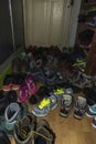 Many sneakers and mountain shoes in the corridor of the Kozya St