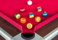 Many snooker balls or pool balls near the corner hole on red table Royalty Free Stock Photo