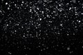 Many snowflakes in blur on black background. Snowfall layer for winter project