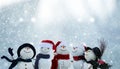 Many snowmen standing in winter Christmas landscape