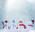 Many snowmen standing in winter Christmas landscape Royalty Free Stock Photo