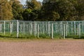 Many soccer goals placed on a field.