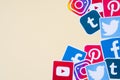 Many social network printed icons lies in pile on beige background with copy space. Facebook Instagram Pinterest Twitter Youtube