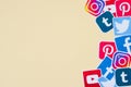 Many social network printed icons lies in pile on beige background with copy space. Facebook Instagram Pinterest Twitter Youtube