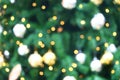 Many soft orange gold blurry bokeh light on green blur Christmas tree background in Christmas and New Year festival day Royalty Free Stock Photo