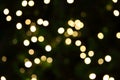 Many soft orange gold blurry bokeh light on green blur Christmas tree background in Christmas and New Year festival day Royalty Free Stock Photo