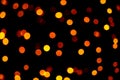 Many soft orange, yellow and red blurry bokeh light on dark tone background in Christmas and New Year festival day Royalty Free Stock Photo