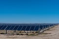 Many solar panels in the desert with blue sky Royalty Free Stock Photo