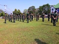 Many soldiers are practicing standing in the outdoor sun.