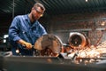 Many of the sparks. Welding the metal. Factory worker in blue uniform is indoors