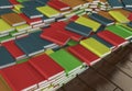 Many stacked colored books