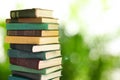 Many stacked hardcover books against blurred background, space for text Royalty Free Stock Photo