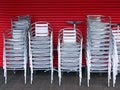 Many Stacked Silver Outdoor Chairs