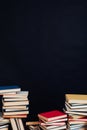 Many stacks of educational books for college exams in the library on a black background Royalty Free Stock Photo