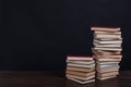 Many stacks of educational books to teach in the library on a black background Royalty Free Stock Photo