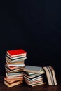 Many stacks of educational books to teach in the library on a black background Royalty Free Stock Photo