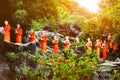 Many statues of Buddhist monks in the garden of Dambulla Cave Temple outside. Sri Lanka.