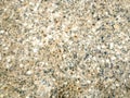 Many stones in concrete as background front view closeup