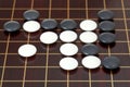 Many stones during go game playing on goban