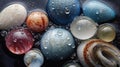 Many stones of various sizes covered with small drops of water after rain. A close up view of smooth polished multicolored pebbles