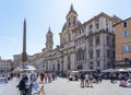 Many street performers in front of the beautiful church Sant Agnese in Agone in Piazza Navona square in Rome, Italy