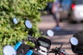 Many street-side scooter mirrors parked against a defocused urban background Royalty Free Stock Photo