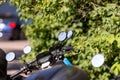 Many street-side scooter mirrors parked against a defocused urban background Royalty Free Stock Photo