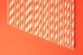 Many striped paper drinking straws on orange background, flat lay Royalty Free Stock Photo