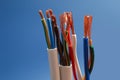 Many stripped electrical cables on blue background, closeup Royalty Free Stock Photo