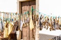 Many strips of salted codfish or bacalao drying in front of a small house in the old town of Peniche