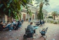 Many students reading books together in garden of the university