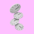 Many stylish clocks falling on pink background