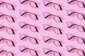 Many reading glasses on pink background pattern Royalty Free Stock Photo