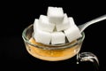 Many sugar cubes on a spoon above hot coffee Royalty Free Stock Photo