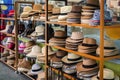 Many summer hats and Panama hats lie on the counter in the shop for tourists. Summer, Thailand.