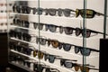 Many sunglasses on display in shop. Display of colorful sunglasses for sale in a street