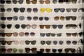 Many sunglasses on display in shop. Display of colorful sunglasses for sale in a street Royalty Free Stock Photo