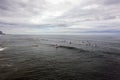 Many surfers on their surfboards on a calm ocean waiting for a wave to ride Royalty Free Stock Photo