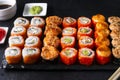 Many sushi , set of Japanese rolls California with caviar, Philadelphia with salmon,baked with cheese and eel, wasabi, pickled