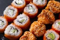 Many sushi , set of Japanese rolls Philadelphia with salmon, California with caviar, baked with eel and cheese , on a black