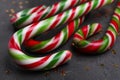 Many sweet Christmas candy canes and shiny confetti on grey background, closeup Royalty Free Stock Photo